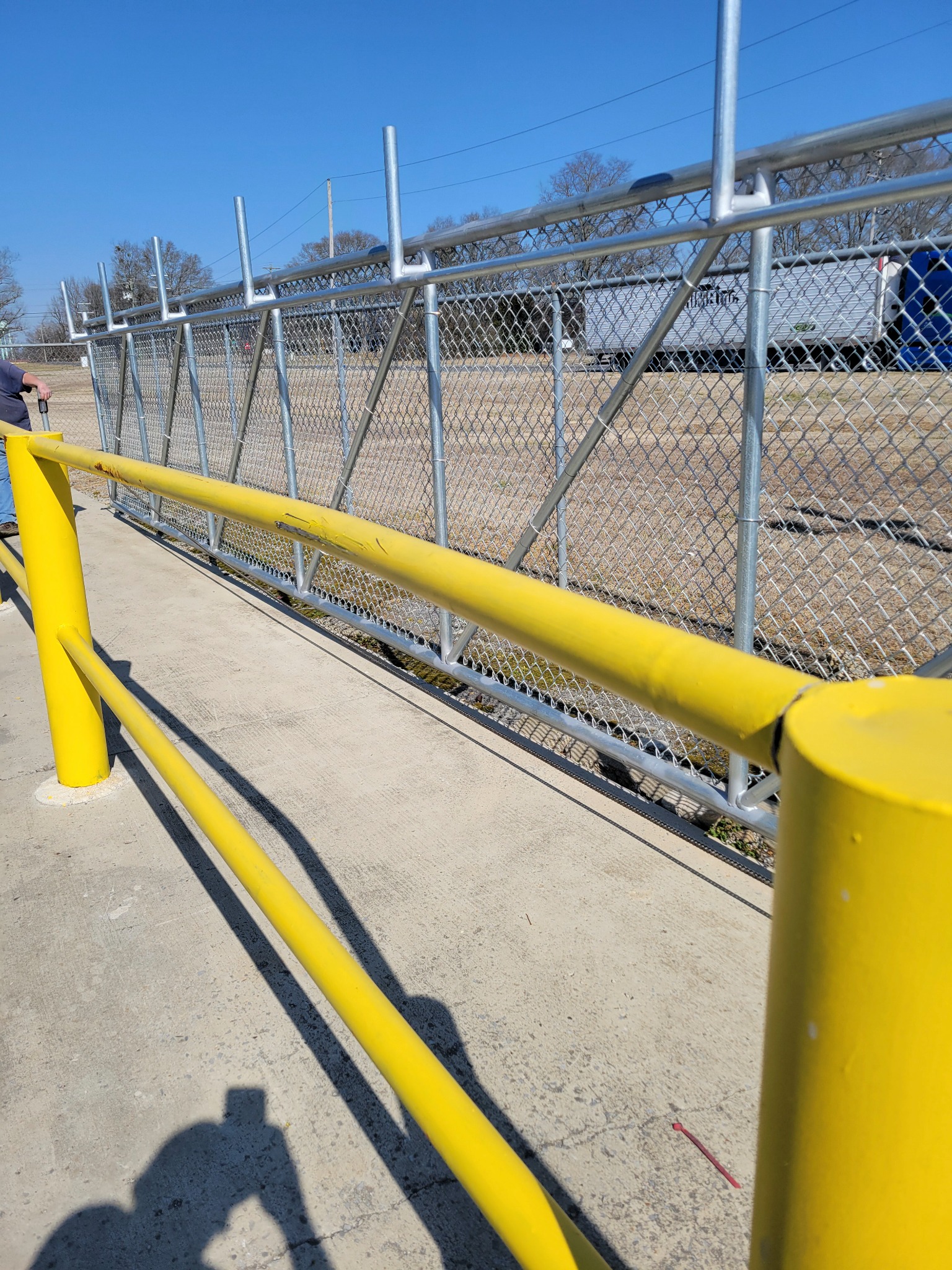 Industrial galvanized chain-link cantilever slide gate installed by Hooks Fence Company in Albertville Alabama