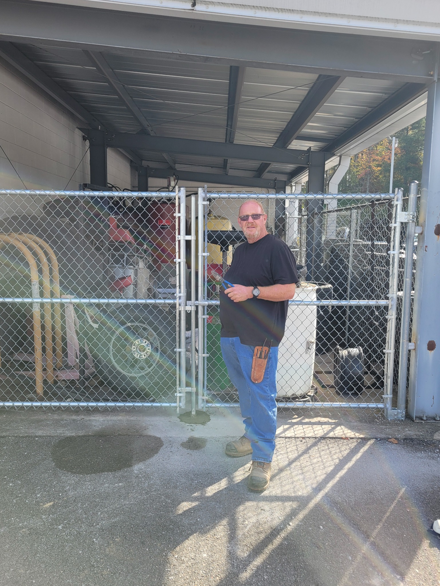 Hooks Fence Company owner Kevin Hooks with commercial chain-link fence installation in Albertville Alabama